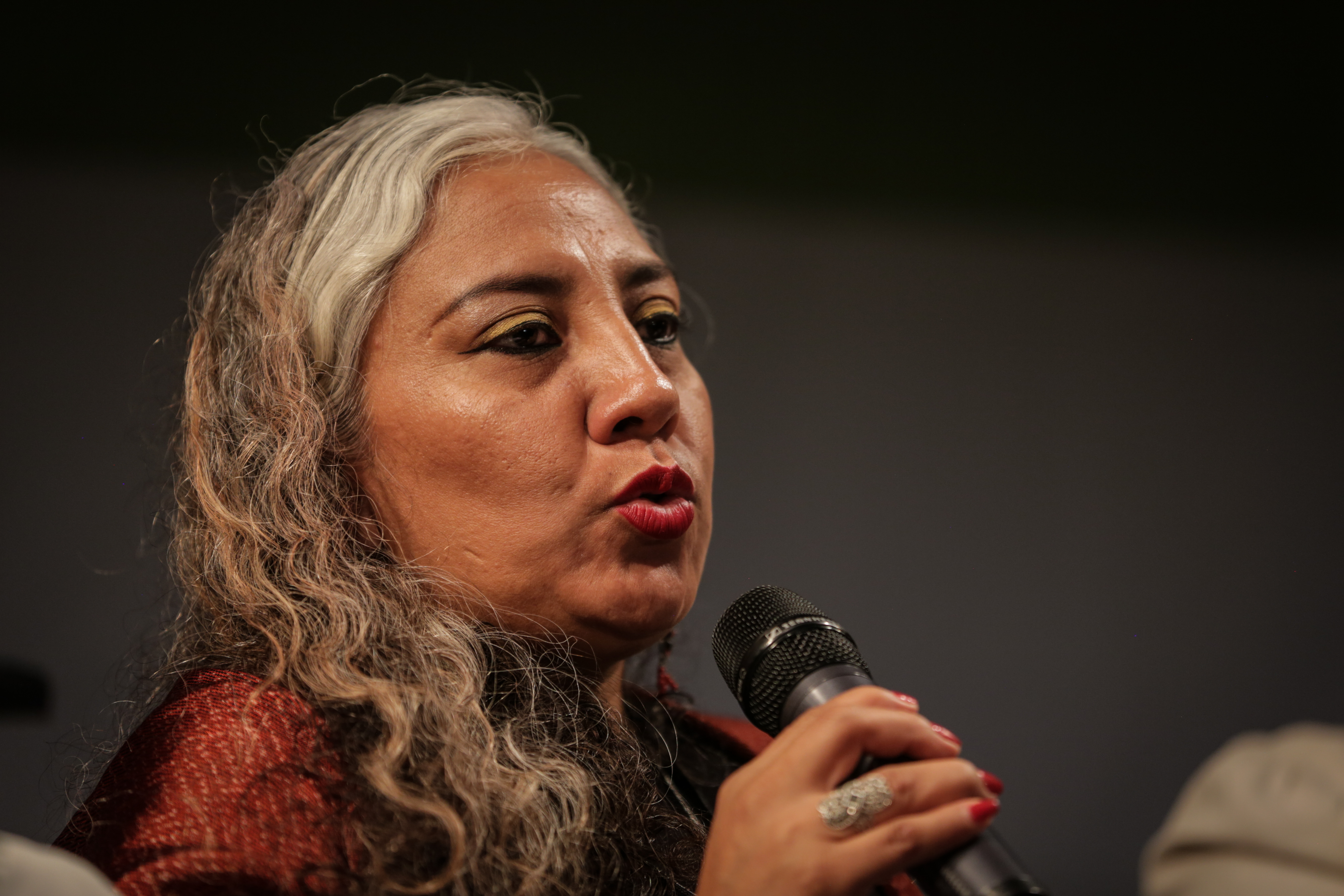 Woman speaking into microphone